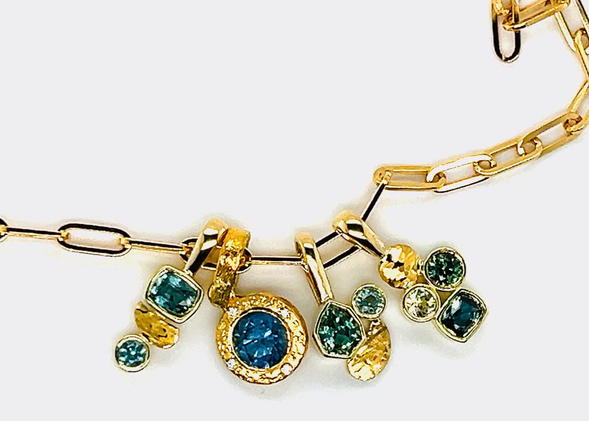 multi colored gemstone charms on a gold chain